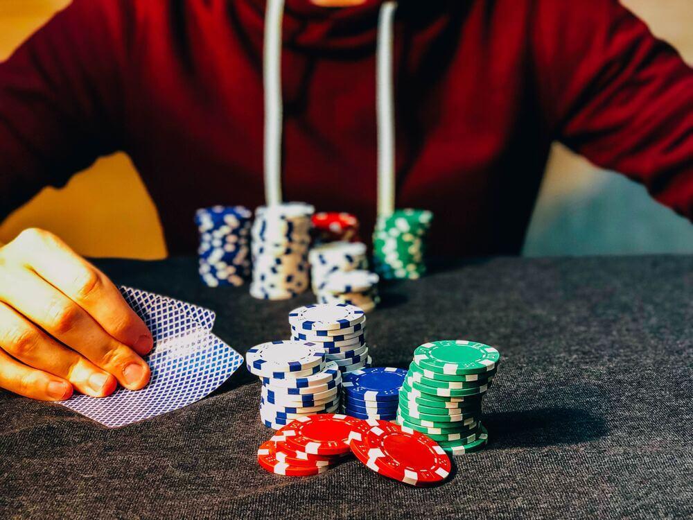 A man sitting near poker chips