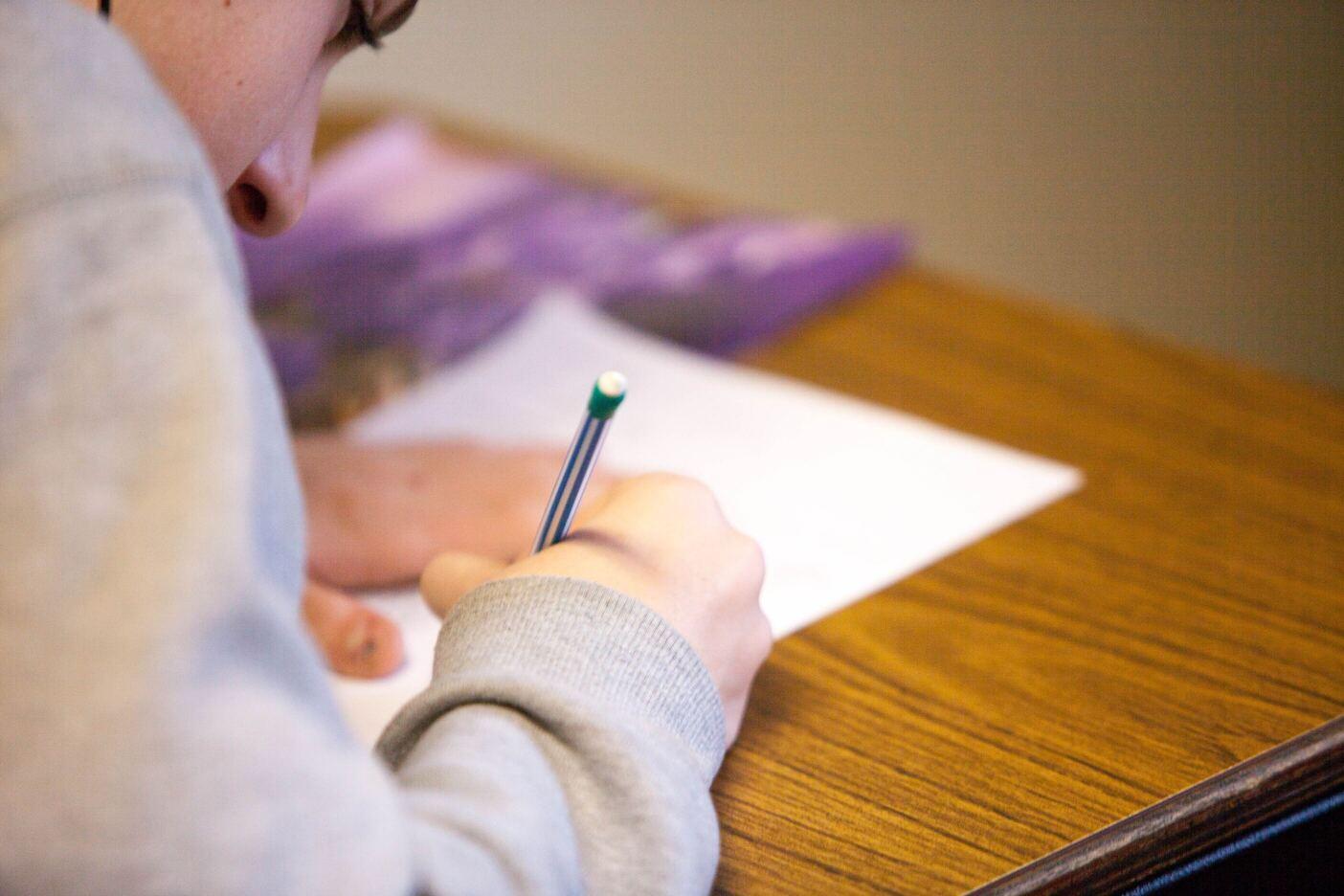 Person taking notes on a paper.